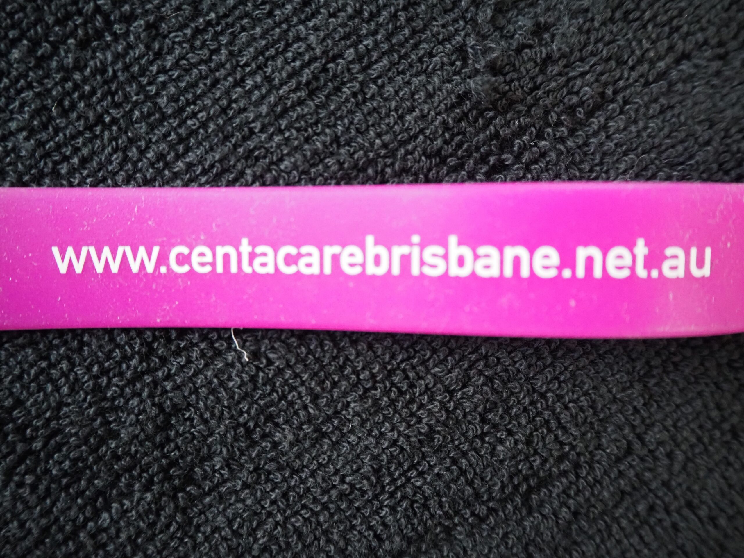 Purple wristband with text: www.centacarebrisbane.net.au beside the best USB type.