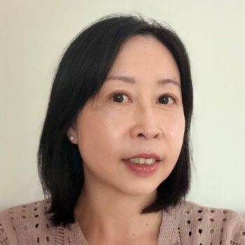 Meet the team: Woman with straight black hair and a beige top smiling at the camera.