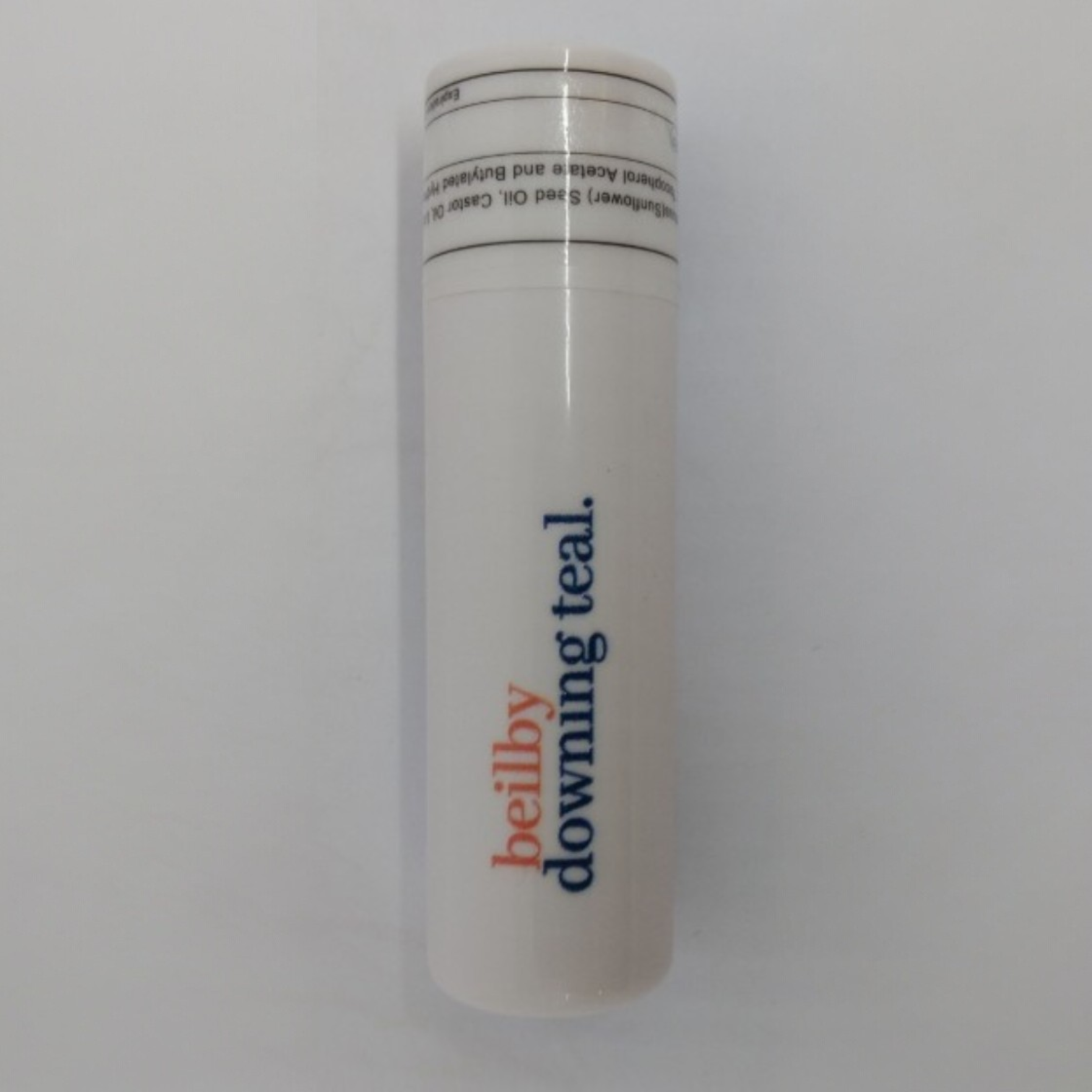 a white lip balm printed with beilby logo.