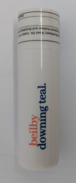 White lip balm with logo of beilby downing teal on it.