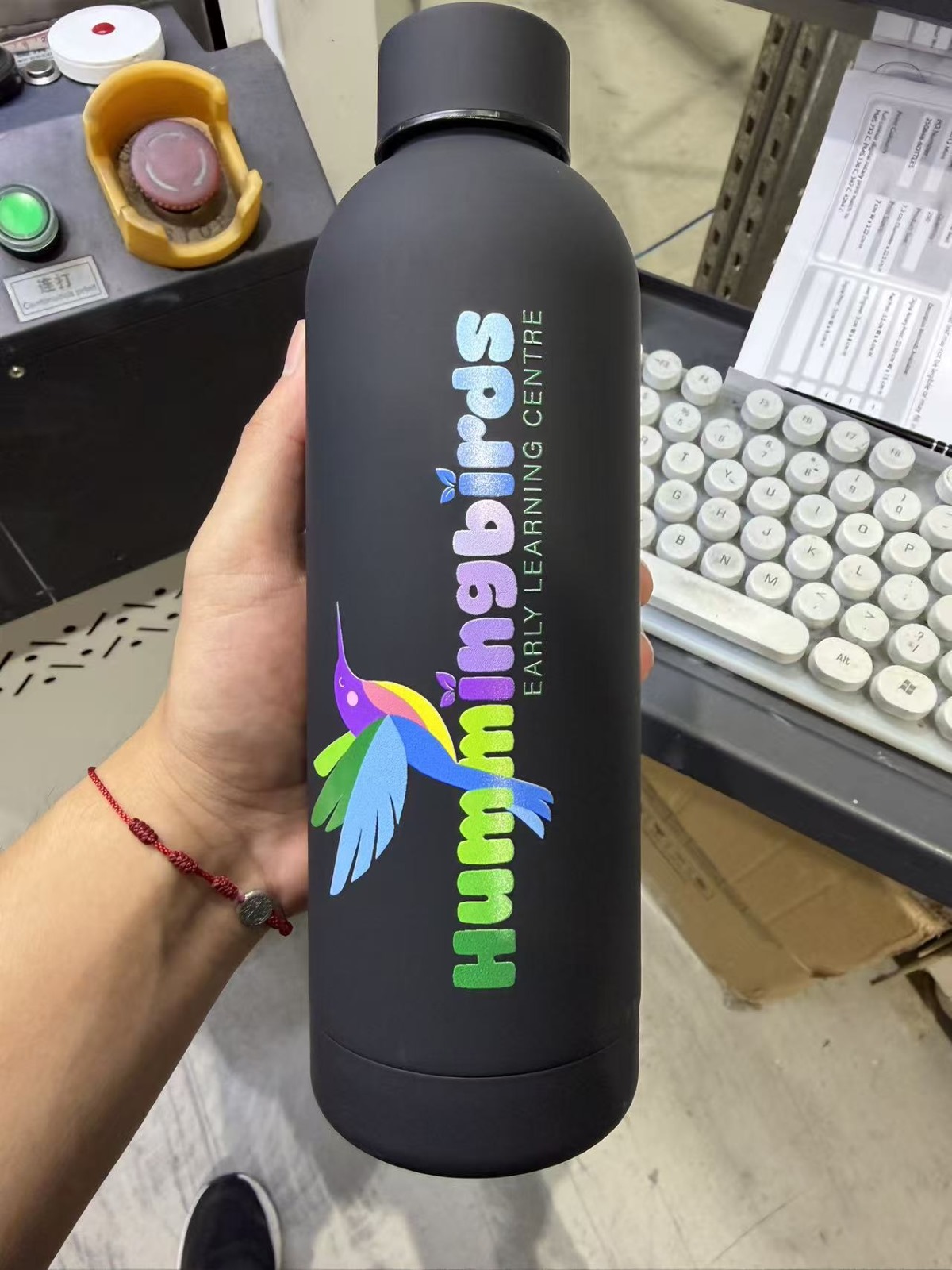 Black bottle with logo printed.