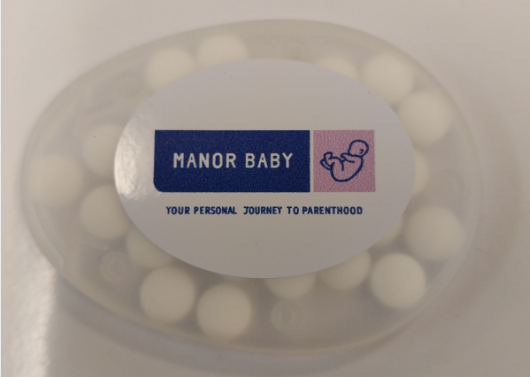 white round mints branded with manor baby logo