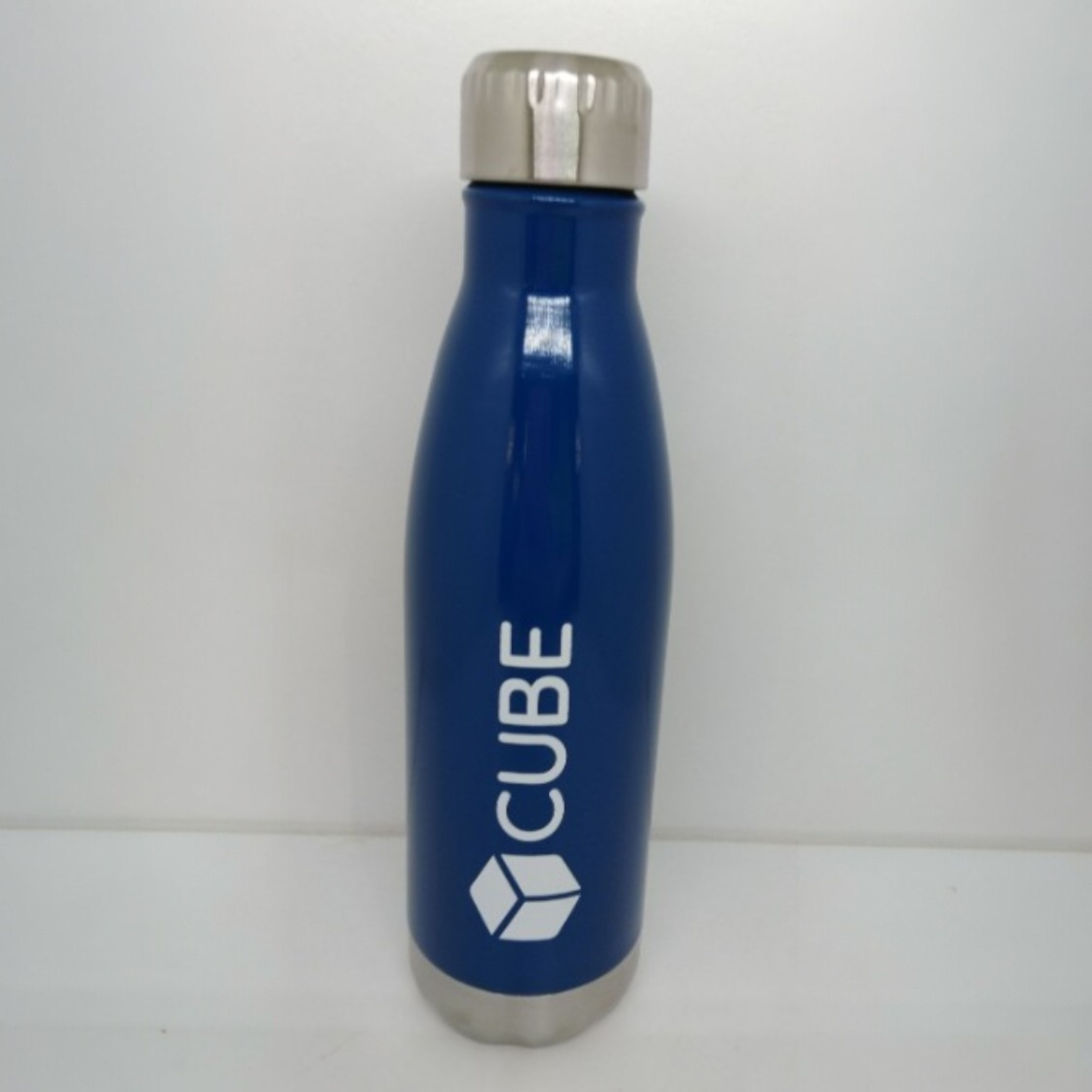 Blue metal water bottle with logo printed vertically on the side.