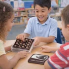 Three kids share 100mm square chocolates at a table with a promo mousepad nearby.