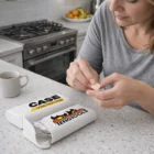 Woman applies a bandage in the kitchen with Medix Bandage Boxes on the counter.