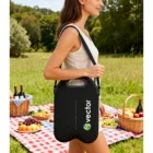 Woman with Party Wine Cooler Bag at a picnic, with fruit baskets and wine in the background.