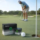A golfer putts on a green near Optima Golf Balls boxes, with a ball beside the hole.
