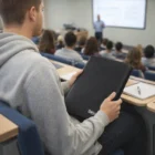 Student uses Tablet Zipped Case in a lecture hall while watching a presentation.