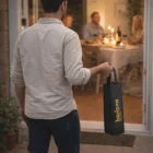 Single man with a Cyprus Wine Tote Bags Single, approaching a dinner table inside a Cyprus home.