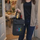 Woman with Aveda Double Wine Cooler Bags entering a dinner party at home.