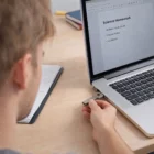 Person uses Enzo 4Gb Key Flash Drive to access Science Homework on a laptop.