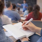 Student takes notes in a Croydon A5 Notebook With Pens during a teacher's lecture.