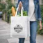Super Shopper carrying groceries in a Super Shopper Mega Tote Bag with “Woodstock Bourbon Cola” logo.