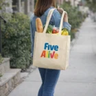 Woman carrying Large Shopping Totes filled with groceries and a baguette.