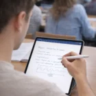 Student using Jotpad Stylus Pens to take physics notes in a classroom.