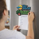 Person sticks a grocery list on the fridge with Kaleo Pvc Fridge Magnets above it.