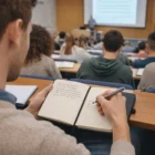 A student uses an Eclipse Notebooks A5 to take notes during a college lecture.
