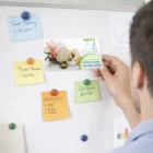 A spa card is pinned on a board with colorful notes and Rectangle Fridge Magnets 9 Cm With Logo.