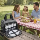A family picnics at a park table with Toronto Custom Decorated Picnic Backpacks.