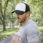 Man jogging in a park, wearing a gray t-shirt and White Panel Trucker Caps Mesh.