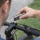 Using Prepper Compact Personalised Multi Tool Set to adjust a bike handlebar bolt outdoors.