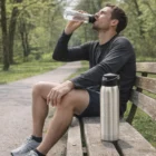 Man on park bench with Helena Branded 500Ml Drink Bottle beside him.