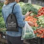 Shopper holding broccoli and Polyester Drawstring Produce Bags at the market.