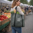 Woman at a farmers market holding a Chic Shopper Heather Tote Bag with Your Logo Here on it.