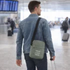 Man at airport with Everyday Custom Branded Travel Bags and a suitcase.