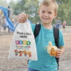 Smiling boy holding a Bondi Drawstring Gift Bag - Medium at a playground.