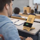 Student in class uses Chartress Wireless Charging Stand with "Your Logo Here" label.