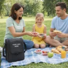 Family enjoying a picnic with Doncaster Picnic Sets and a custom logo cooler bag on the blanket.