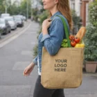 Woman carrying Shaine Jute Tote Bags - Coloured Handles with groceries on a city street.