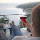 Relaxing with red wine in Luigi Bormioli Atelier 440Ml glasses, enjoying the waterfront view.