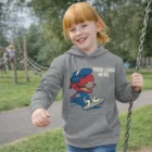 Smiling child in Sols Slam Kids Hooded Sweatshirt with cartoon dinosaur and Your Logo Here.