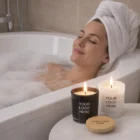 Woman relaxing in a bubble bath with two Serenity Scented Candles nearby.