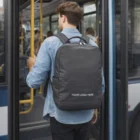 Man with a Moleskine Ripstop Backpack boards a city bus.