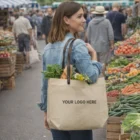 Woman at Eglinton farmer’s market with an Eglinton Tote Bag full of fresh produce.