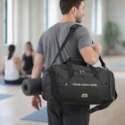 Man with a Rory Duffle Bag and yoga mat, two people sitting in the background.