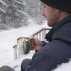 Man in winter clothes holds a Tuscaloosa Mule Mug, snowy Tuscaloosa in the background.