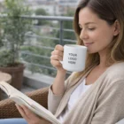 Woman reading with a Yarra Brew Coffee Mug on a balcony.