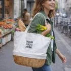 Smiling woman carries groceries in a Keepsake Wicker Tote Bag with blank logo space on a city street.