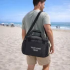 Man on beach carrying a Chillpak Cooler Bags 20L with YOUR LOGO HERE.
