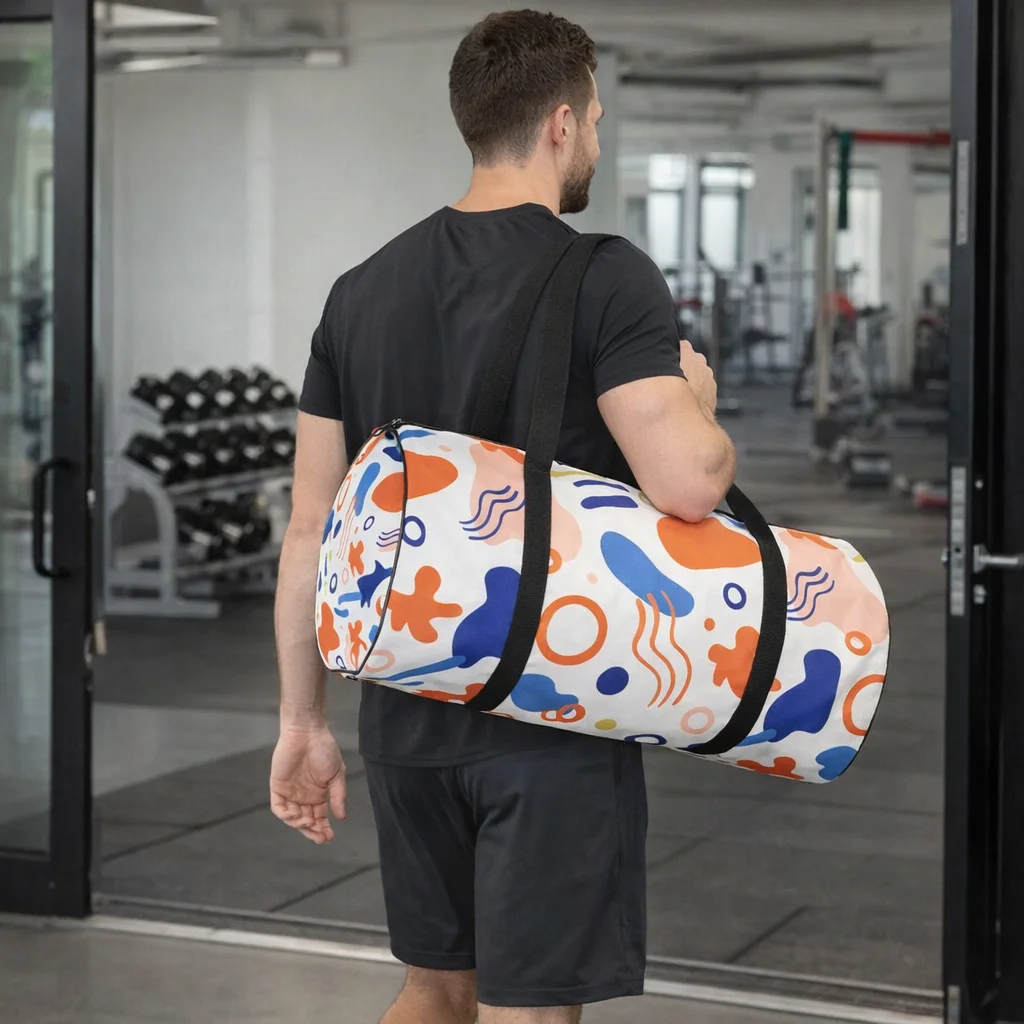 Man in gym carrying a Full Colour Sublimated Duffle Bag with an abstract pattern over his shoulder.