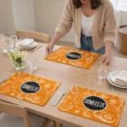 Woman sets table with Full Colour Sublimated Place Mats and elegant glassware.