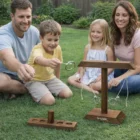 Family enjoying Pine Ring Toss Games together outdoors on the grass, all smiling.