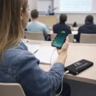Student charges phone with a 10,000mAh Power Bank during a classroom lecture.