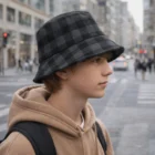 Teen boy on city street wears a Plaid Bucket Hat and hoodie, showcasing Plaid Bucket Hats.