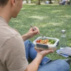 Relax on the grass with books while enjoying healthy Spice Calypso Lunch Boxes.
