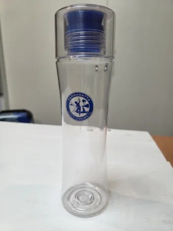 Clear plastic water bottle for all age groups, blue cap, Parramatta City Council logo on front.